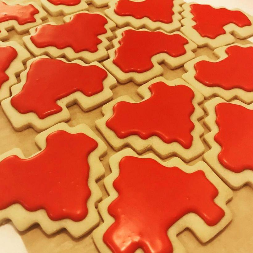 Shortbread cookies cut into 8-bit heart shapes and decorated with bright red royal icing.